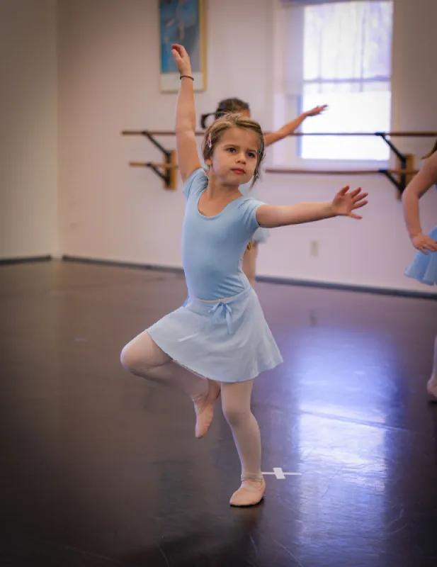 A young girl balances during a Fantasy Ballet class
